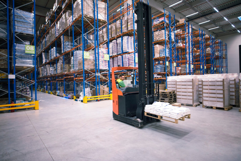 worker-operating-forklift-machine-relocating-goods-large-warehouse-center_342744-44.jpg