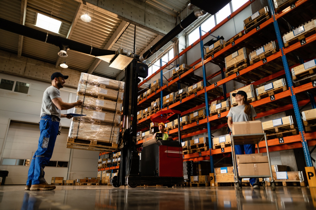 low-angle-view-happy-warehouse-workers-communicating-while-working-with-shipment-industrial-storage-compartment.jpg